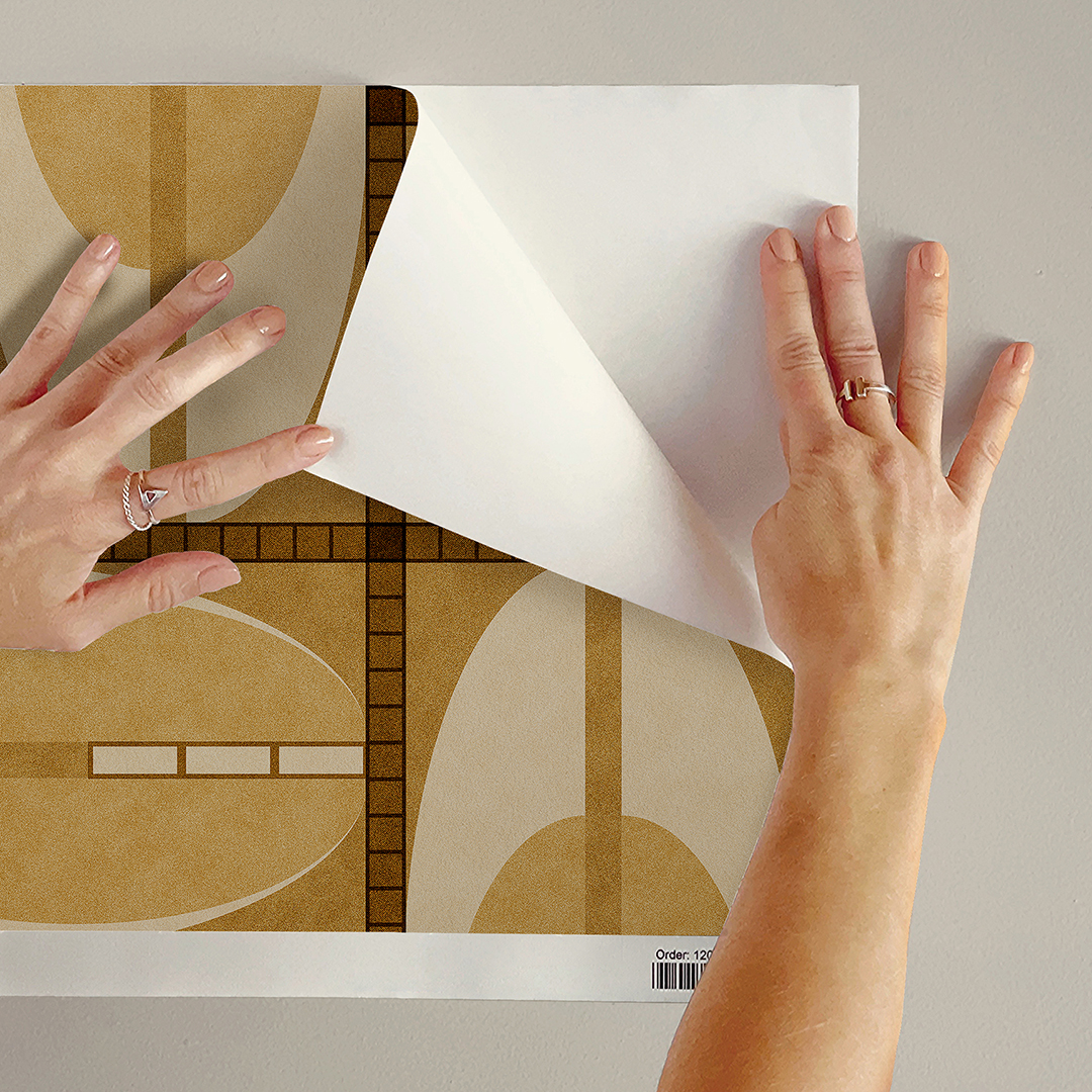 The artwork features a repeating geometric pattern of symmetrical shapes resembling elongated, curved diamonds or petals in various shades of blue and green. Each shape is split vertically with one half filled with a light blue and the other half filled with green or darker blue. The background is a light, almost pastel blue, which provides a soft yet vibrant backdrop. One of the blue shapes near the upper left contains a white starburst element, adding a focal point of brightness to the composition. The overall design conveys a modern, mid-century aesthetic with clean lines and harmonious color contrasts.